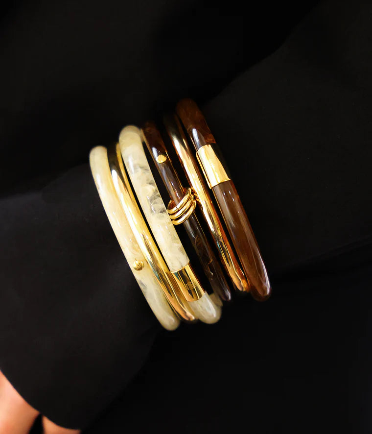 Bracelet jonc Ayana Zag Bijoux porté au poignet, bijou doré et marbré élégant